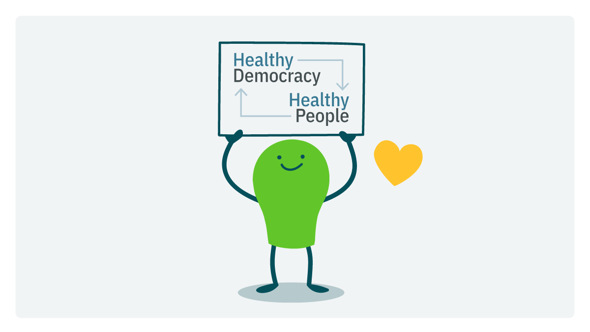 A doodle holds up a sign with the Healthy Democracy, Healthy People logo.