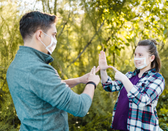 Two people communicating with sign language