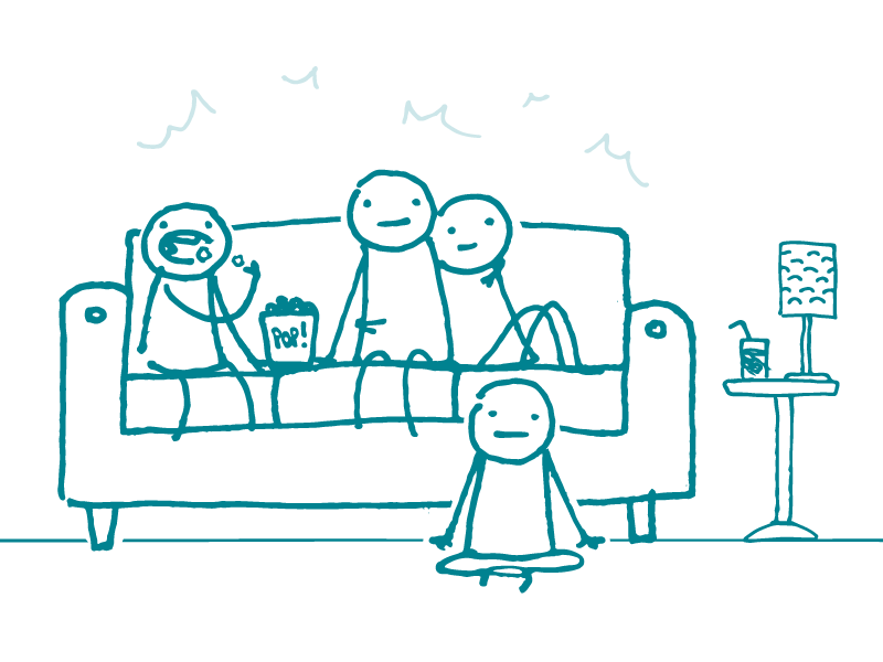 Four doodles are gathered in a living room staring forward, as if watching a screen. One is eating popcorn.